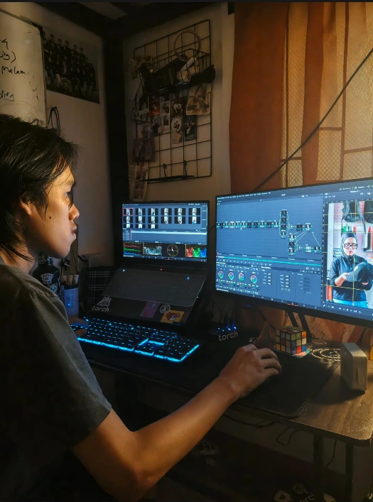 Dimas editing footage late at night on DaVinci Resolve.